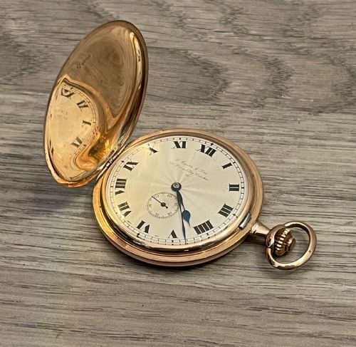 Front view of the 9ct gold full hunter pocket watch with lid opened, showing the dial, hands, crown, and bow