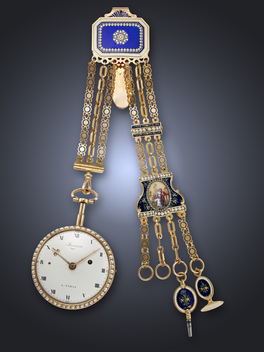 Front view of the openface pocket watch alongside its matching gold, enamel, and pearl-set chatelaine and key
