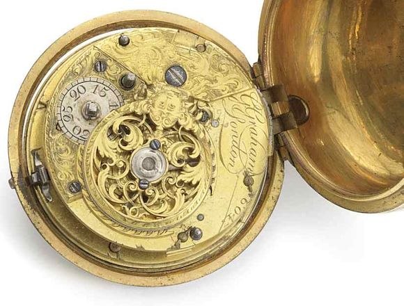 Top plate view of the gilt full plate movement showing the engraved balance cock, regulator, and signature