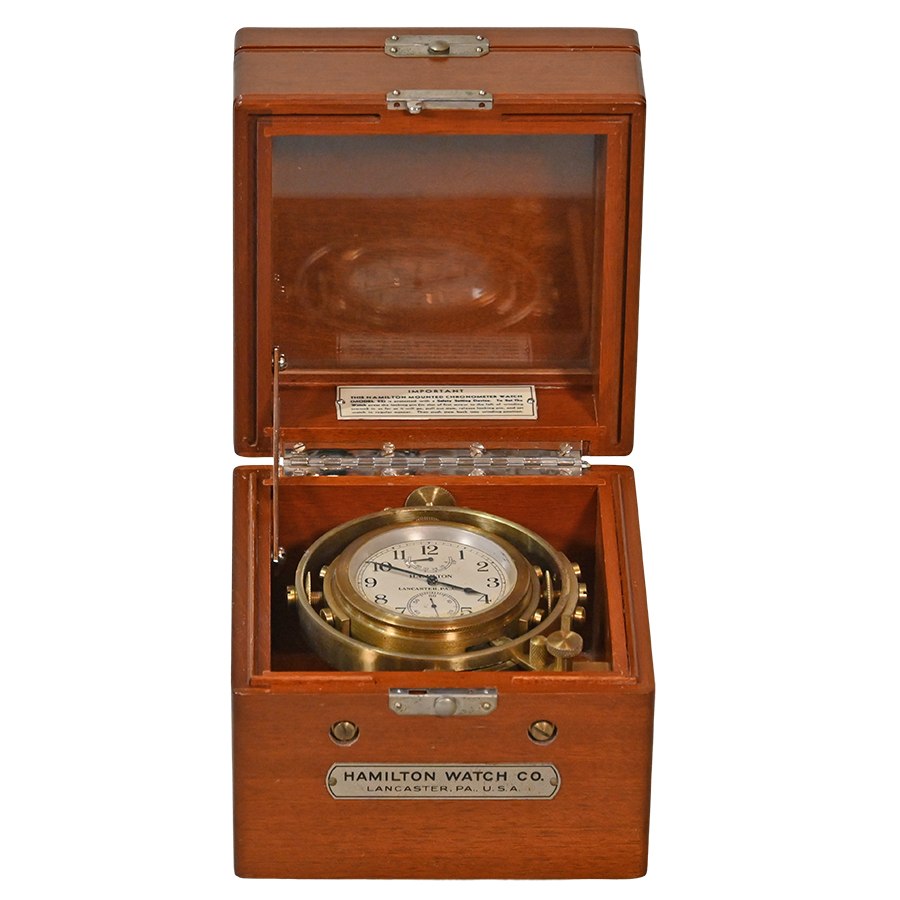 Front view of Hamilton Model 22 deck watch mounted in brass gimbal within its mahogany box