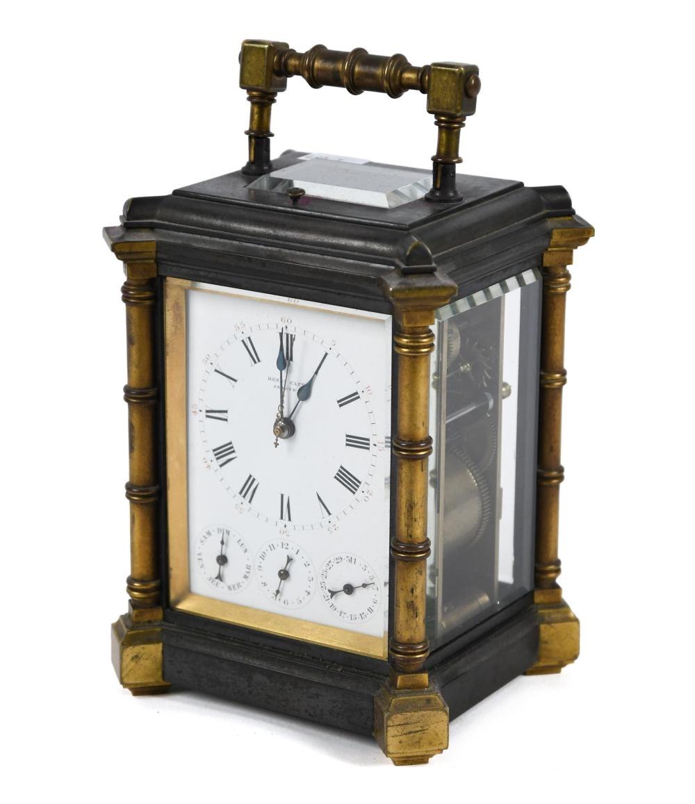 Three-quarter front view of the Henry Capt carriage clock showing bamboo-style corner pillars and calendar dials