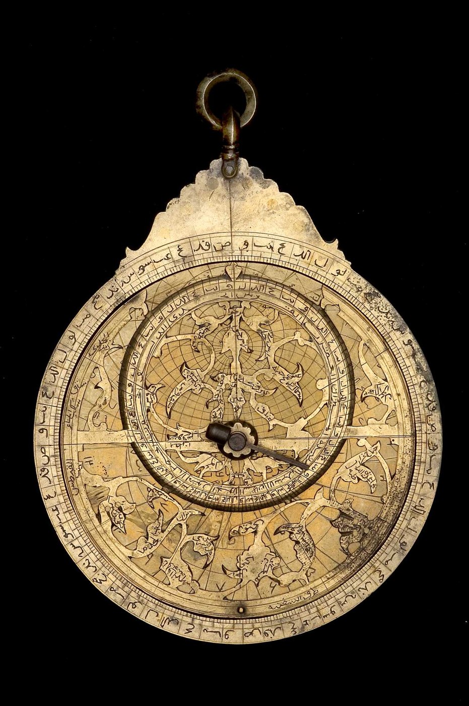 Front view of the brass astrolabe showing the rete, throne, and circular scales.