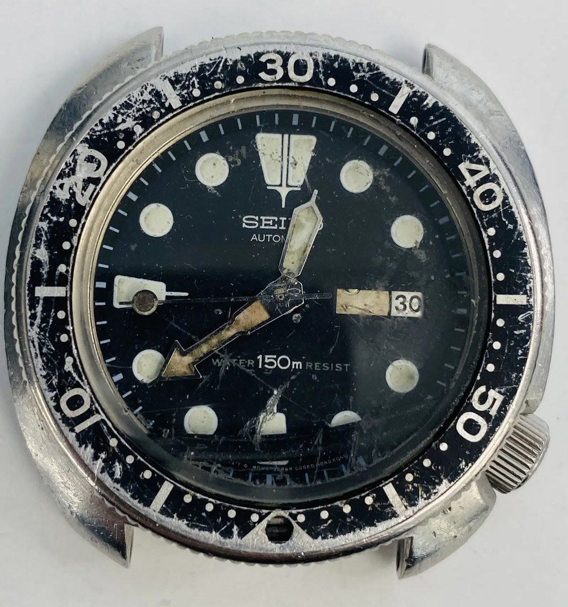 Front view of the Seiko 6309-7049 watch head showing the bezel, crystal, dial, hands, and crown.