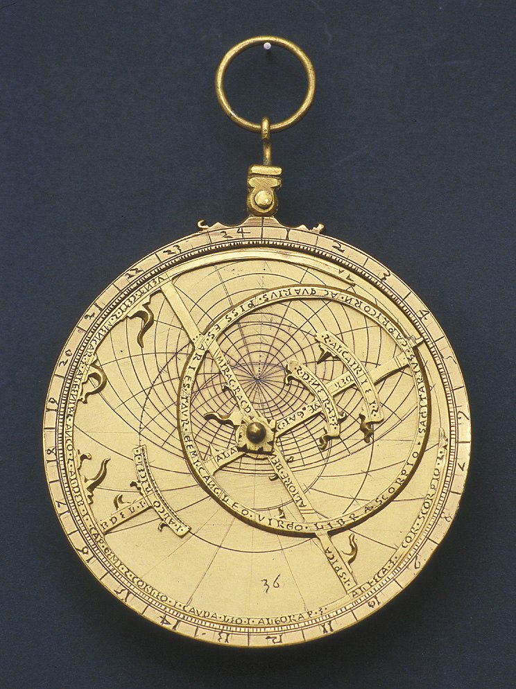 The face of the 16th-century gilt copper astrolabe showing the rete, pointer, and zodiac engravings.