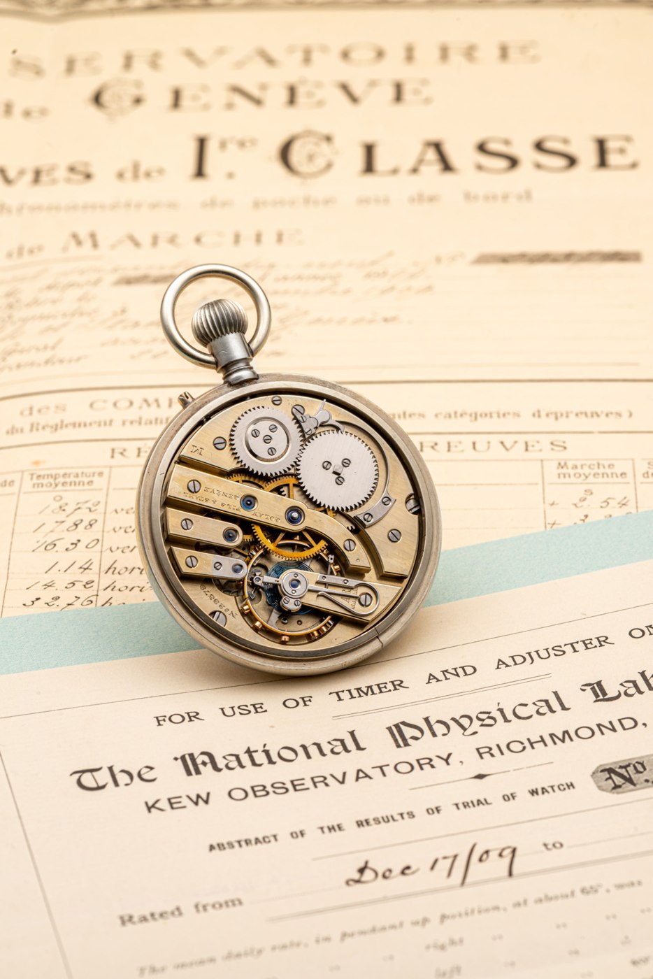 The movement of the Golay Fils & Stahl chronometer resting on the original observatory certificates.