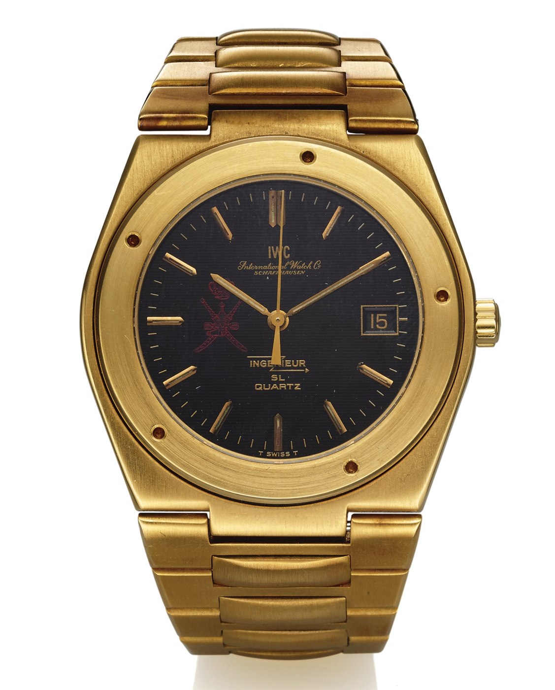 Front view of the IWC Ingenieur SL Quartz, Ref. 9701, showcasing the black textured dial with the red crest of Oman and the integral gold bracelet.