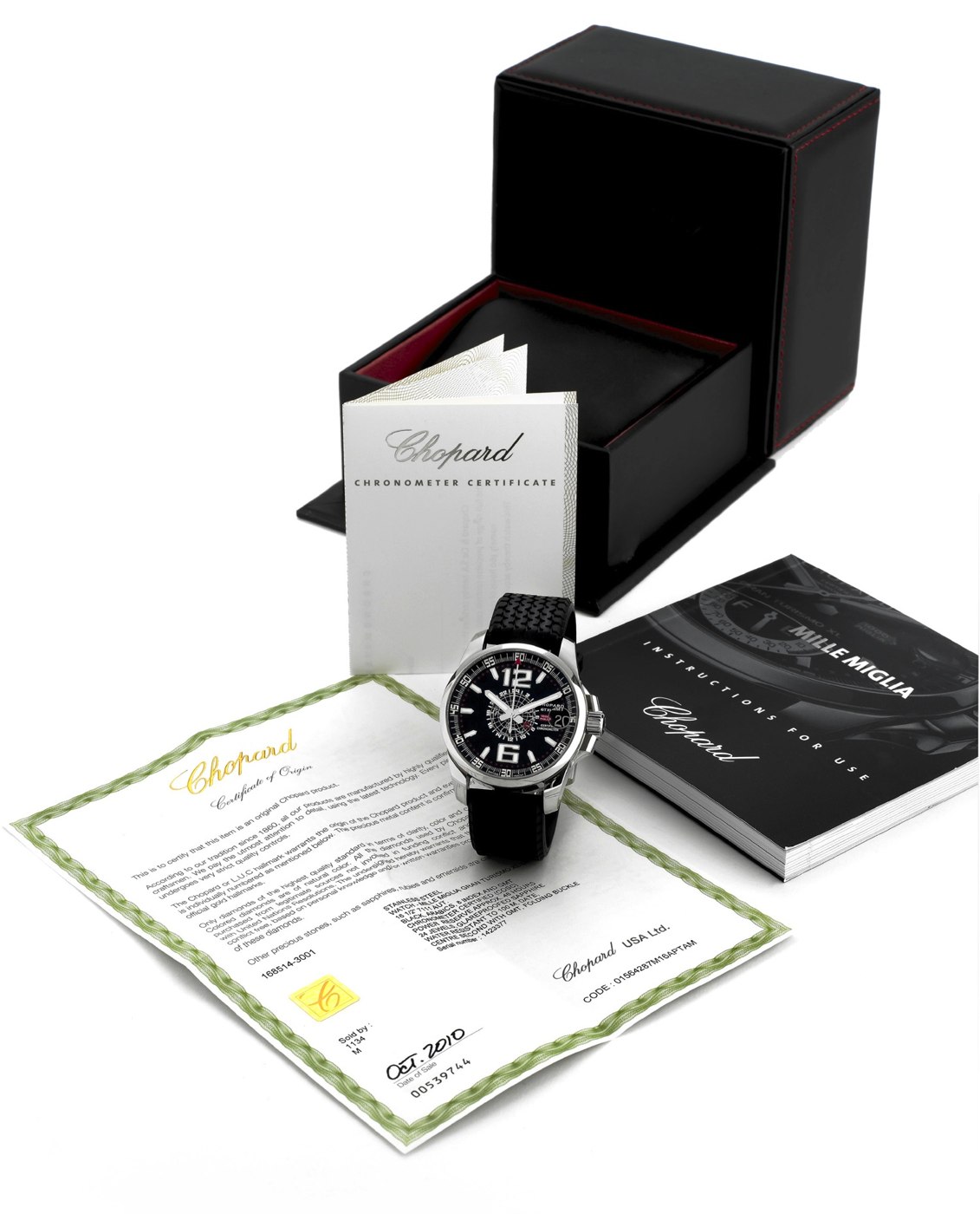 The watch is presented with its original box, warranty document, and instruction manual.