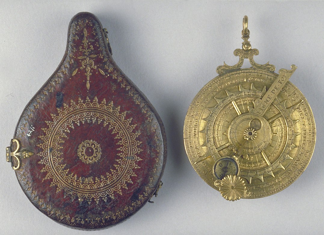 A gilt brass nocturnal and its tooled red leather storage case.