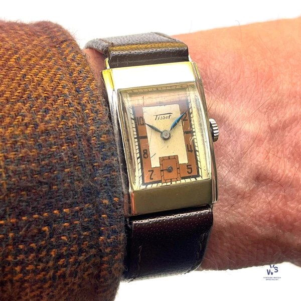Wrist view of the Tissot Art Deco tank wristwatch showing the two-tone dial and faceted crystal