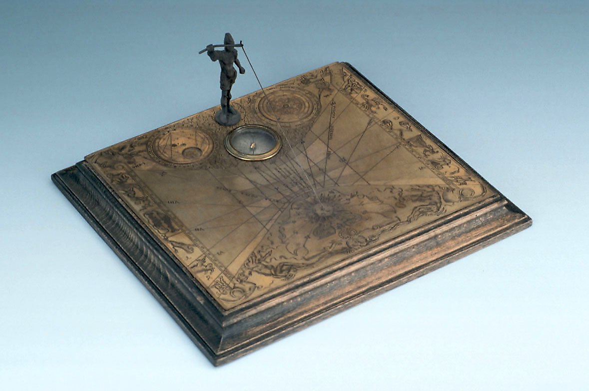 Horizontal sundial with a silver soldier figure supporting the gnomon and two integrated astrological volvelles.