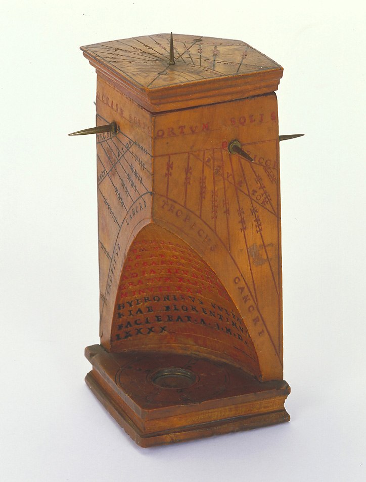A wooden polyhedral sundial, inventory number 2460, featuring multiple gnomons, an integrated compass in the base, and an inscribed conical recess.