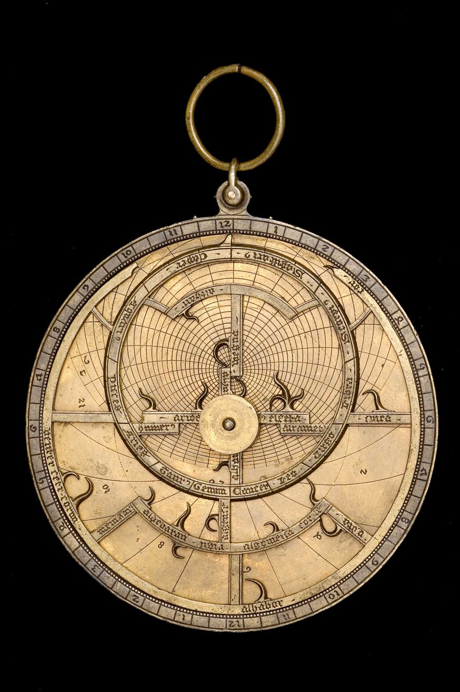 Front view of the brass astrolabe showing the rete, star pointers, and ecliptic scale.