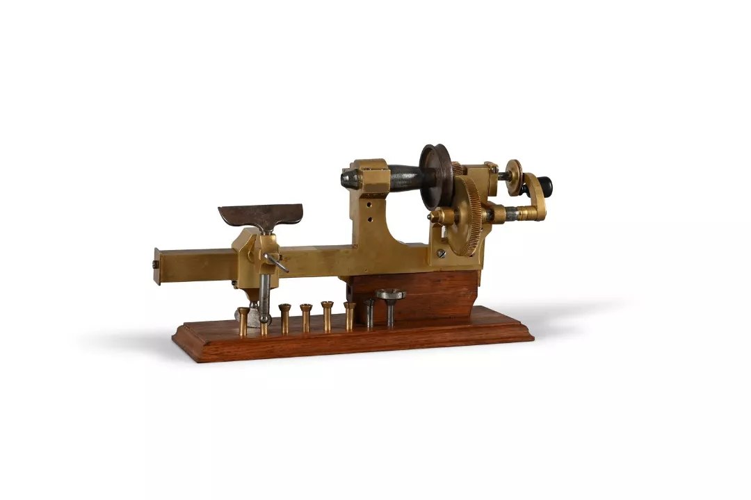 Front oblique view of the mandrel-frame lathe mounted on a wooden plinth with collets