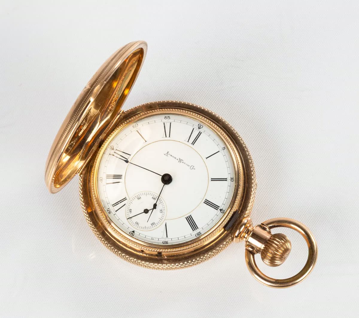 Aurora Watch Co. 14K gold pocket watch with open front lid showing the dial and winding crown