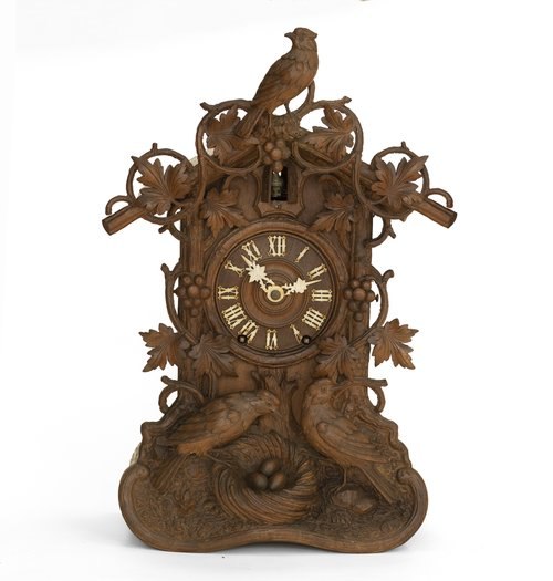 Front view of the carved wooden Beha model 589 cuckoo clock case, dial, and hands