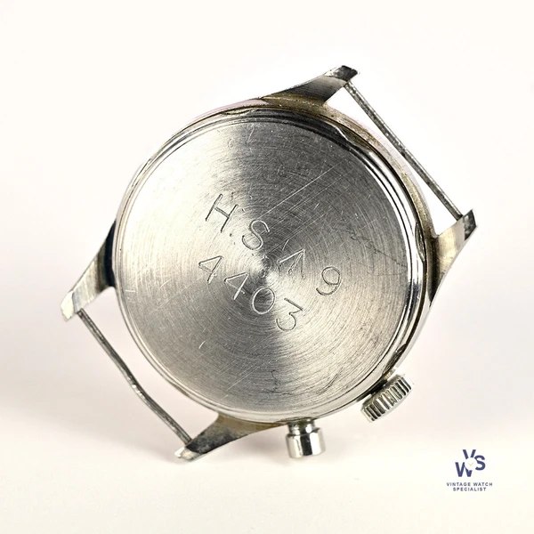Case back view of Lemania Series 2 chronograph showing military issue engravings 'H.S. ^ 9' and '4403', single pusher, and fixed lug bars