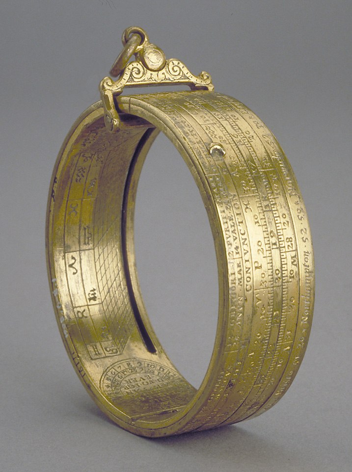 The gilt brass ring dial by Humfrey Cole, displaying the external engraved scales and suspension mechanism.