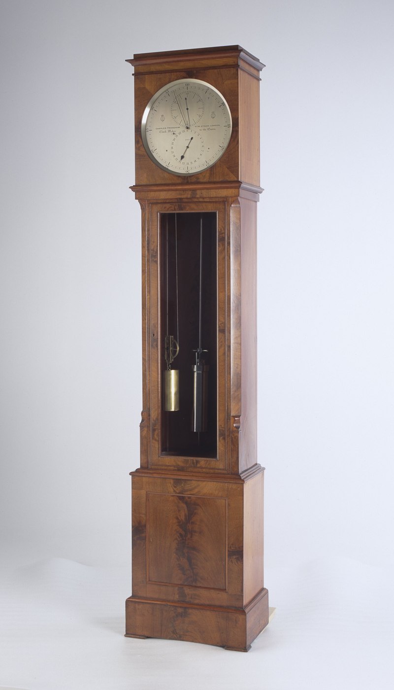 The Frodsham Regulator clock showing its wooden long-case and dial configuration.