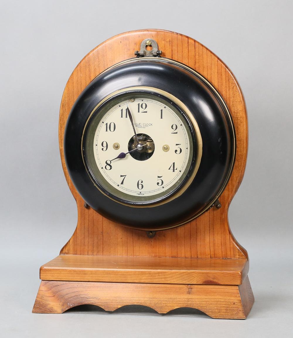 Front view of Bulle Model G electric clock on arched wooden mount