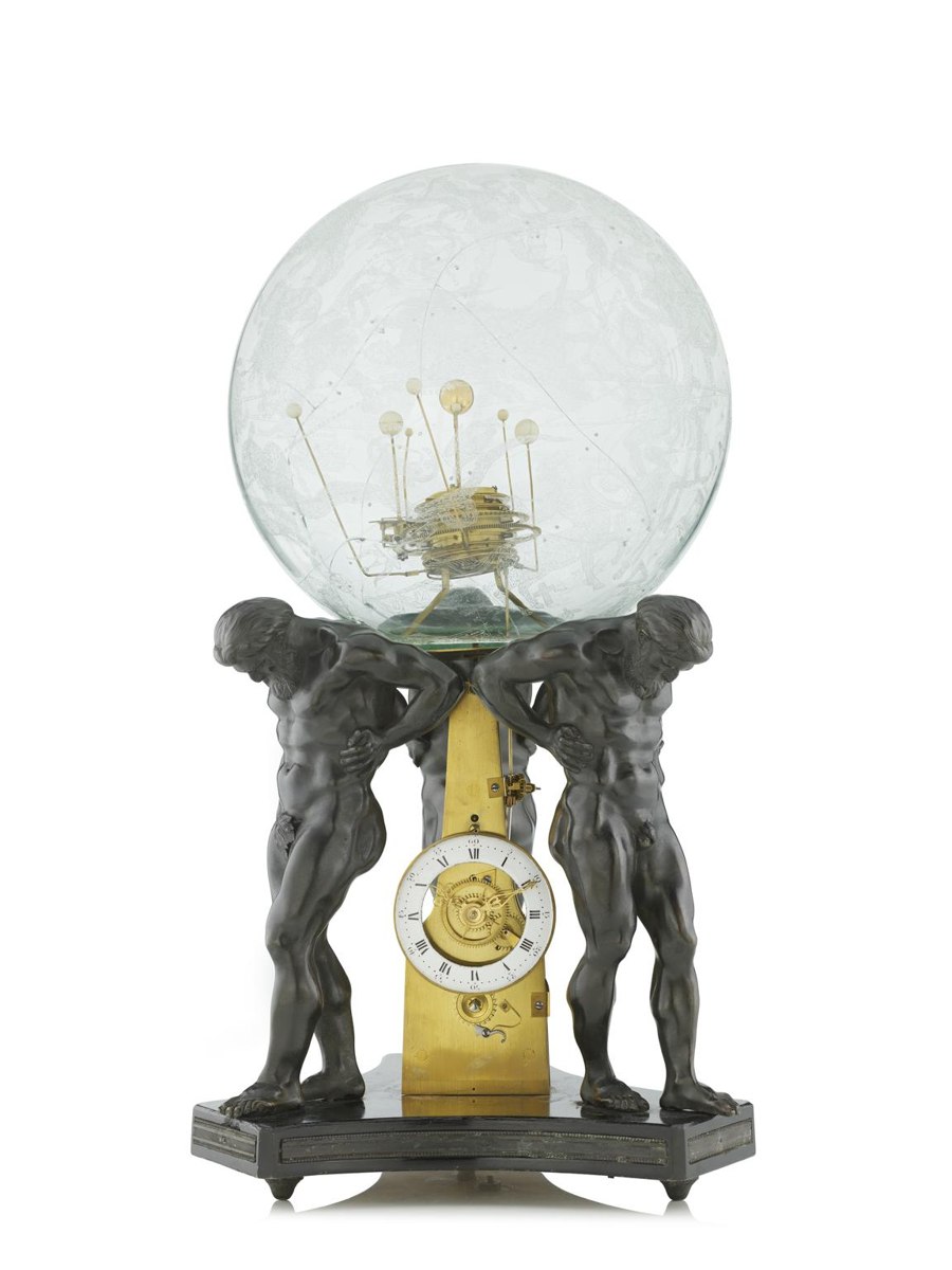 Front view of the orrery clock showing the Atlas figures, dial, and glass celestial sphere containing planetary mechanism