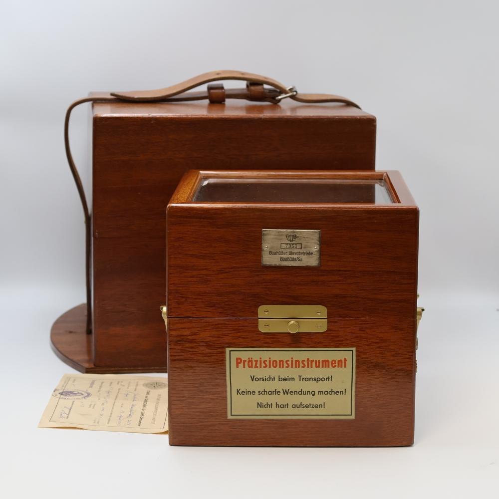 The GUB marine chronometer in its mahogany transport box, with the included certificate visible.
