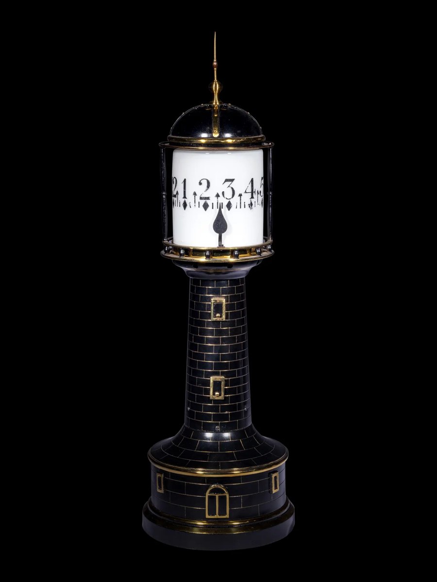Full frontal view of the gilt and patinated lighthouse annular clock