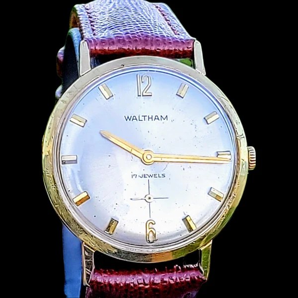 Dial and case view of the Waltham manual-wind wristwatch with leather strap