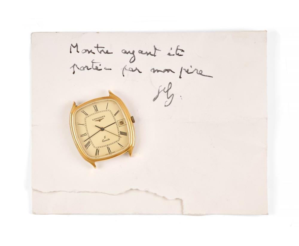 The Longines quartz wristwatch shown with a handwritten note.