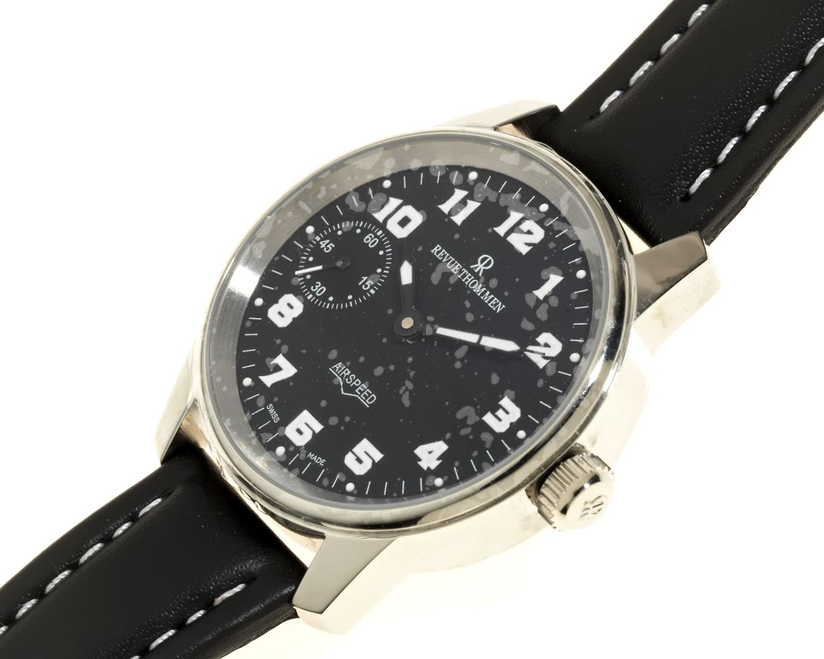 Oblique front view of the Revue Thommen Airspeed wristwatch showing black dial, crystal degradation, and leather strap