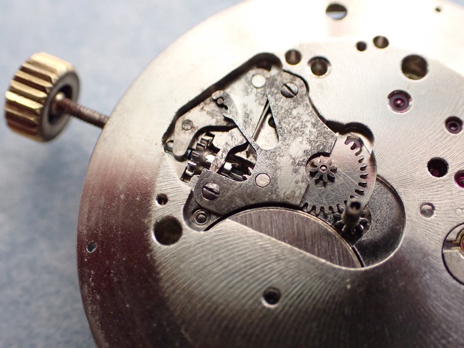 Universal Genève 138SS keyless works with the sliding pinion on the stem — source reports a missing tooth; in-situ context, not an isolated pristine clutch wheel