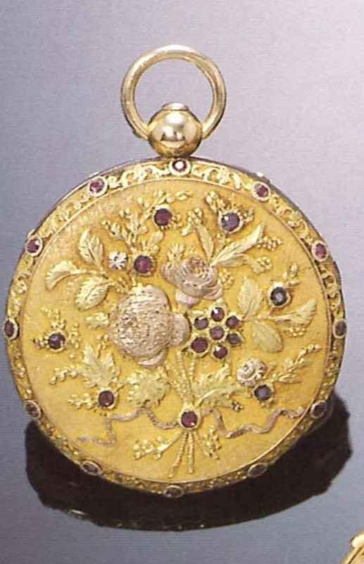 View of the watch case cover, featuring chased gold floral decoration and inset stones against an amati ground.