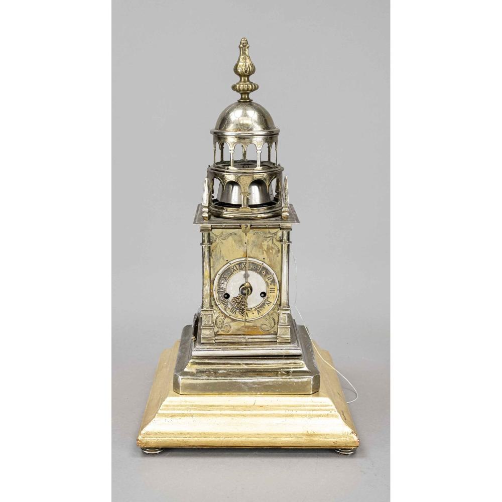 Front view of the silver-plated brass tower clock on a gilded wooden base