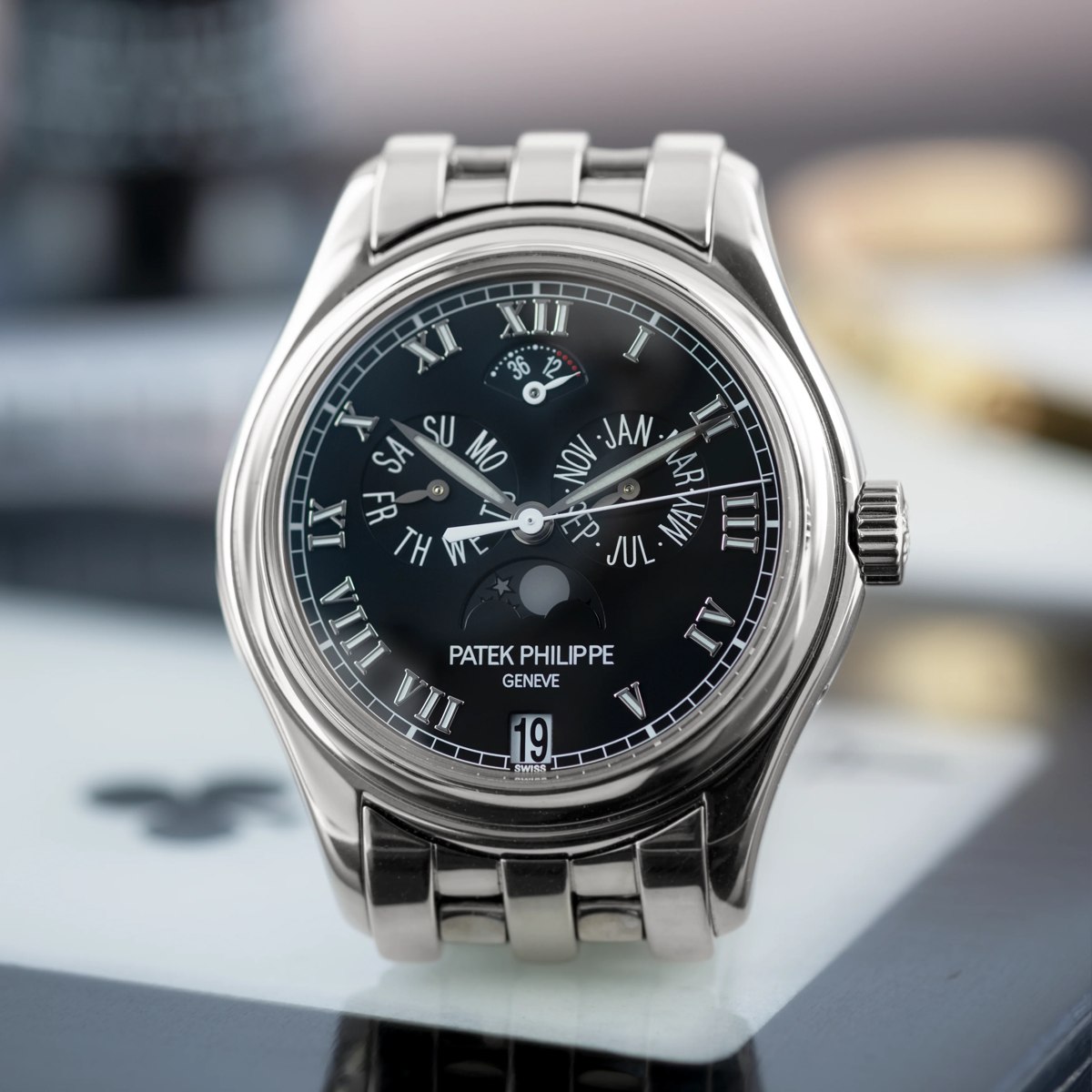 Patek Philippe Annual Calendar Ref. 5036/1G-013 in 18K white gold with black dial and integrated bracelet.