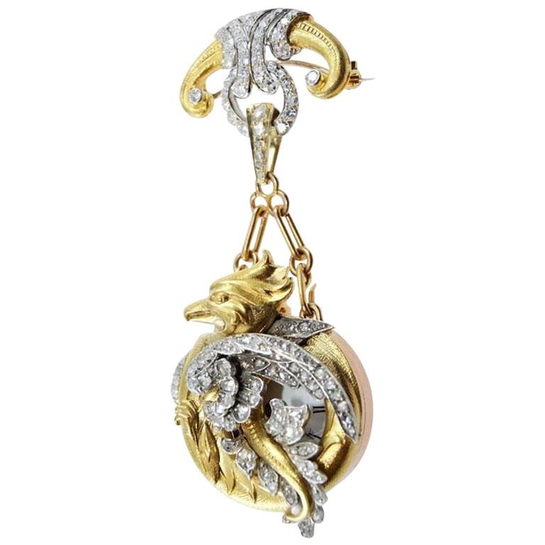 Diamond and 18kt yellow gold dragon pendant watch suspended from a brooch mount