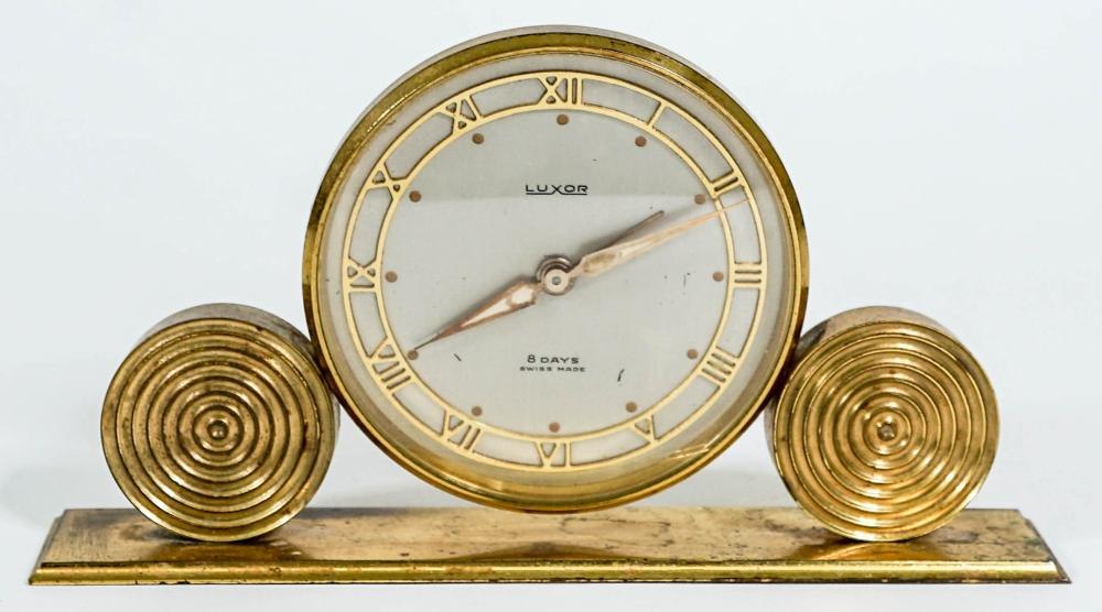Front view showing the Luxor dial, Roman numerals, and the concentric ring design on the base.