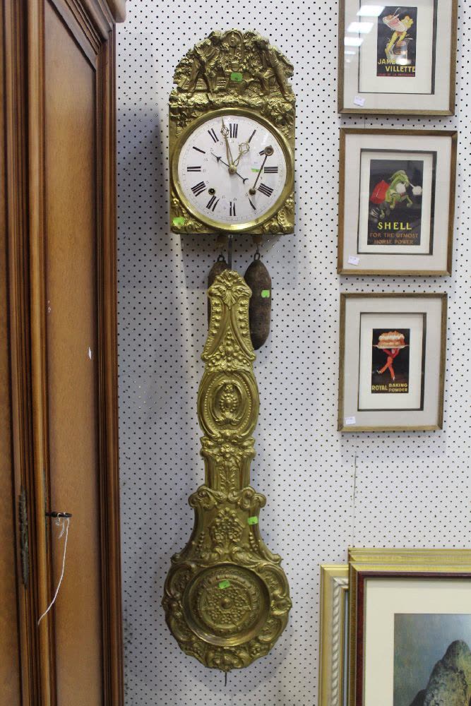 Antique French comtoise clock with embossed brass surround, pendulum, and weights
