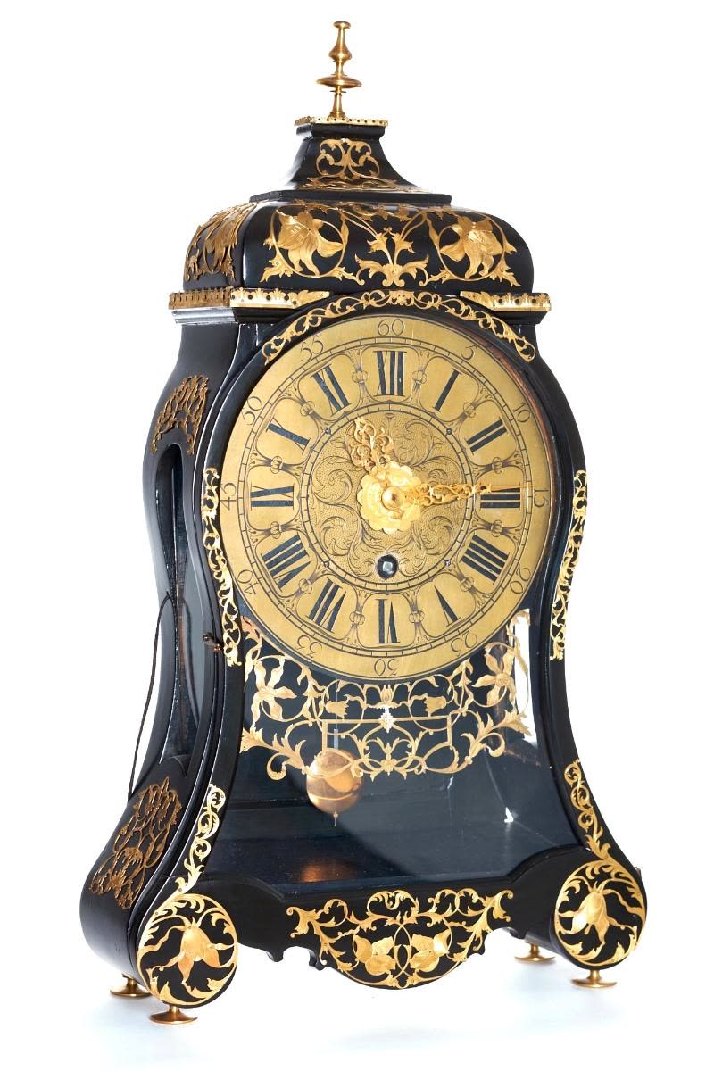 The curved, black painted wooden case is decorated with engraved and pierced brass appliques featuring interlaced scrollwork and tulips (MIH IV-413)