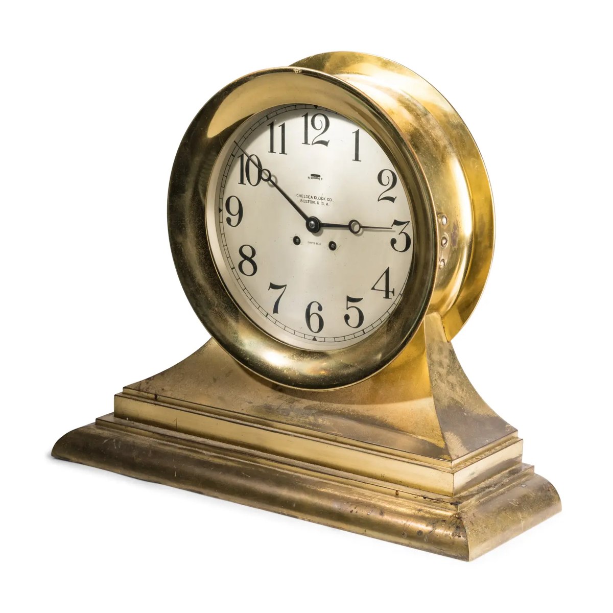 Front three-quarter view of the brass Chelsea ship's bell mantel clock on stepped base