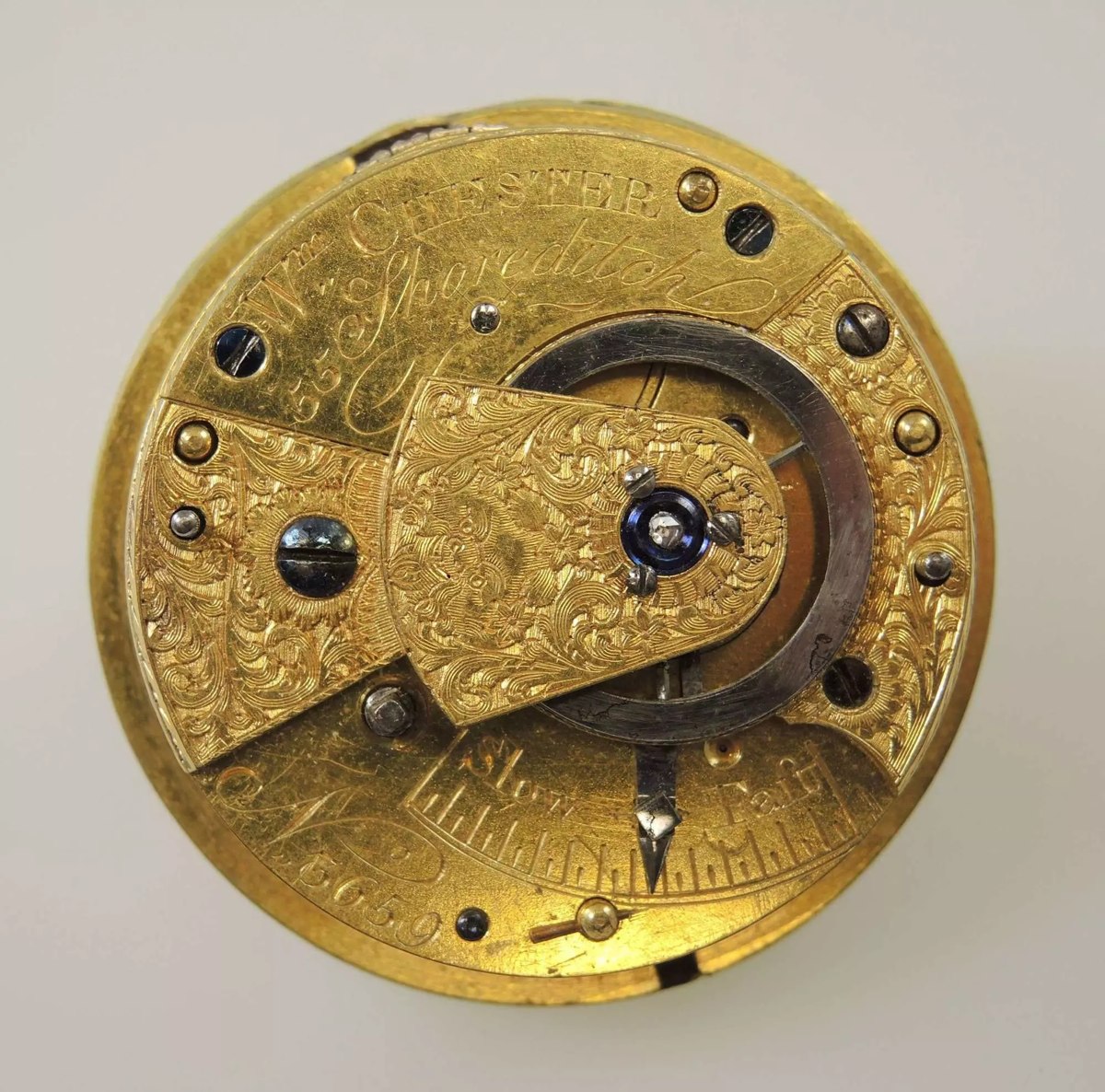 Back plate view of the Wm. Chester verge fusee movement showing the engraved balance cock and diamond endstone