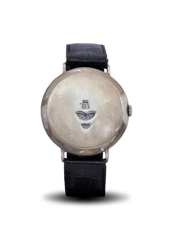 Front view of the nickel digital jump hour wristwatch showing three digital apertures and black leather strap