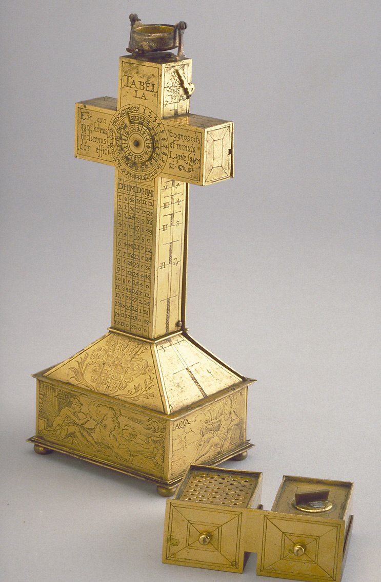 The crucifix dial showing the open internal drawers and the lunar volvelle on the vertical arm.