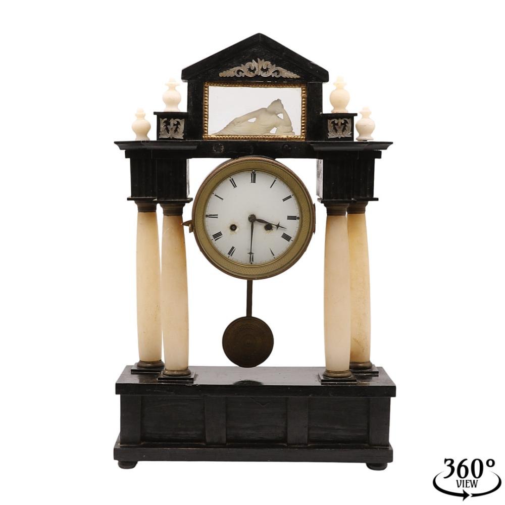 Biedermeier portal clock with four alabaster columns and a reclining figure in the pediment.