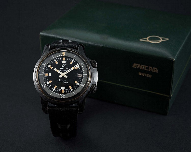 Front view of Enicar Sherpa OPS wristwatch with black dial and perforated strap, positioned in front of its green presentation box