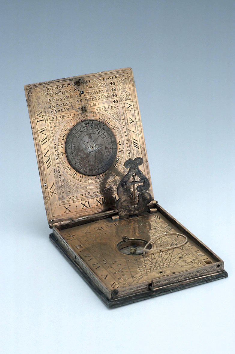 Interior view of the 1598 gilt brass diptych dial by Georg Karl, showing the lunar volvelle, hour scales, and integral compass.