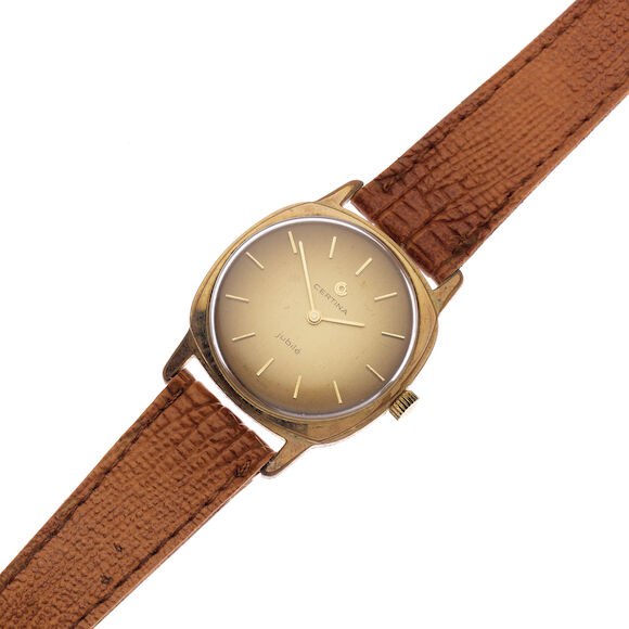 Front view of the Certina Jubilé gold-plated manual wind wristwatch with cushion case and textured brown strap