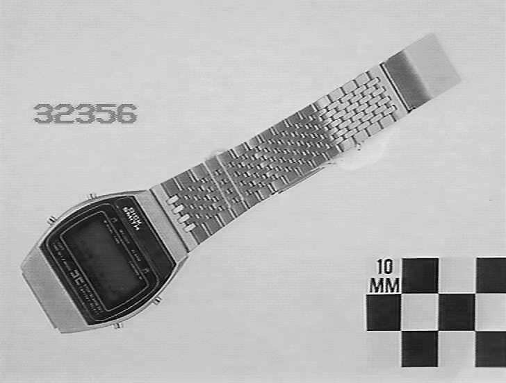 A digital wristwatch with a stainless steel link band, featuring an LCD display screen and marked 'Dick Smith'.