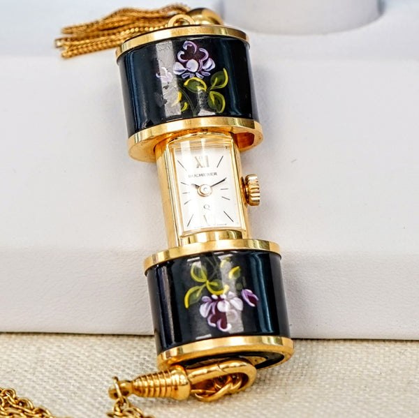 Pendant watch shown in the opened position displaying dial and floral enamel covers