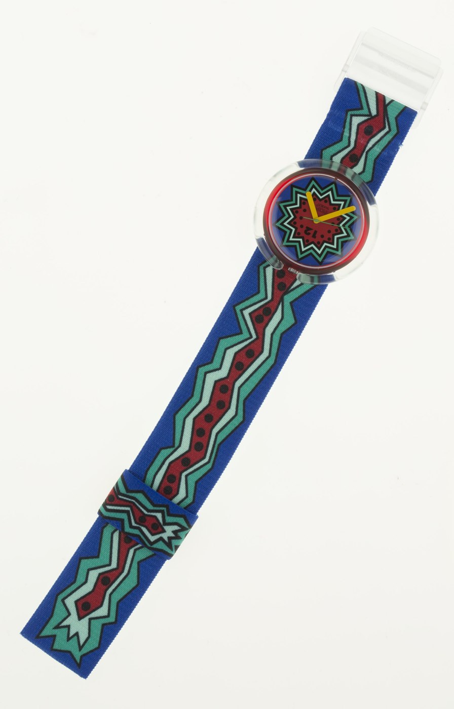 The Swatch 'Point Waves' wristwatch showing the patterned dial and elastic strap.