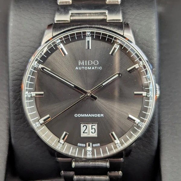 Dial view of the Mido Commander Big Date automatic wristwatch on presentation cushion
