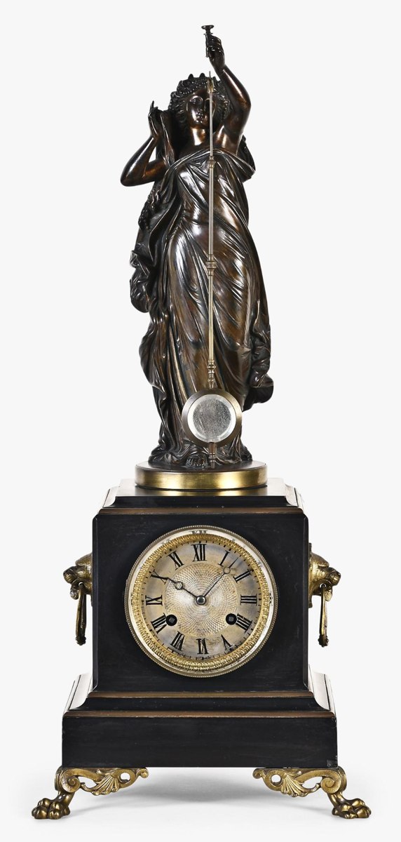 Frontal view of the bronze and black marble Guilmet mystery clock showing the figure, pendulum, and dial
